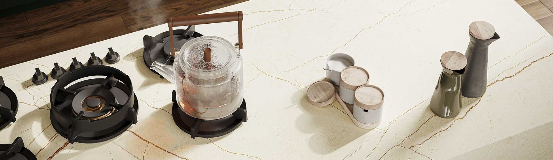 Modern kitchen featuring PITT cooking burners integrated into Caesarstone quartz countertop with natural stone veining.