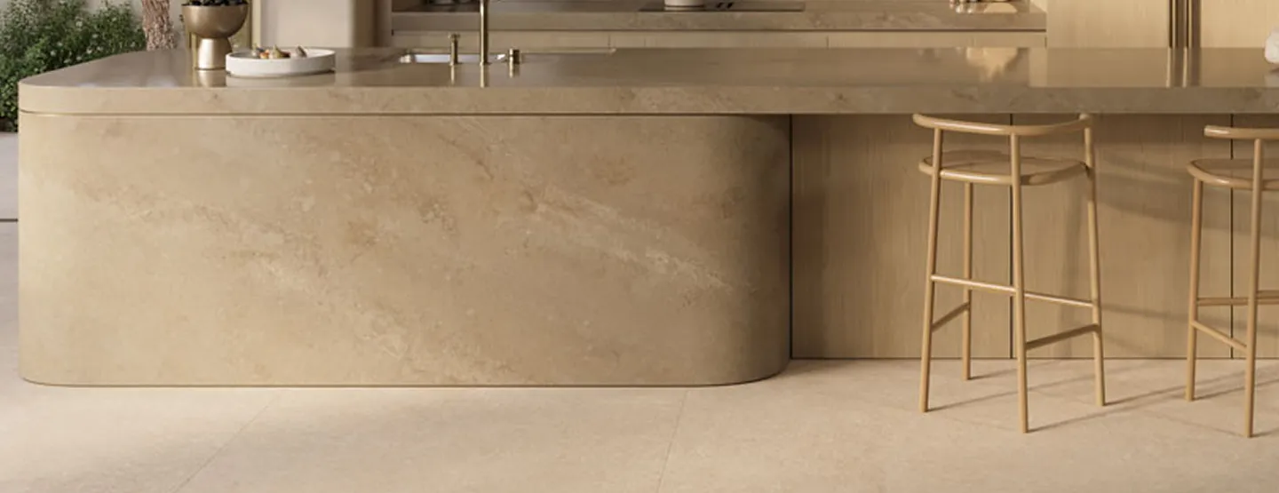 Modern beige kitchen with curved island, pendant lights, and minimalist design.