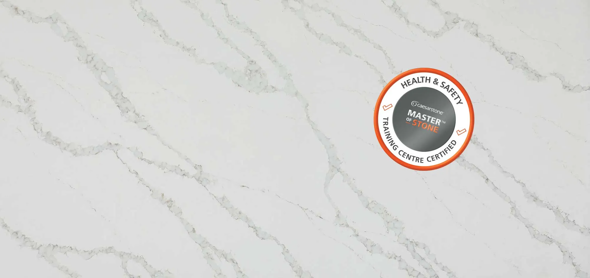 Caesarstone 8103 Calacatta Nobella quartz surface featuring the Master of Stone Health & Safety Training Centre Certified stamp.
