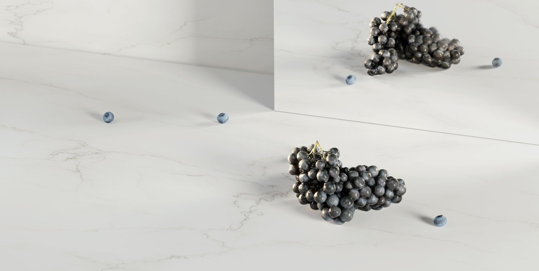 Caesarstone white Porcelain 501 Snowdrift surface with black grapes